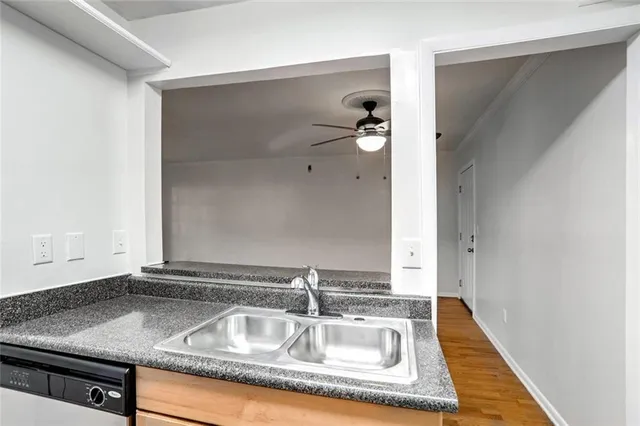 a bathroom with a granite countertop sink and mirror