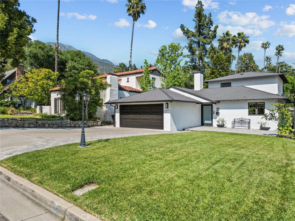 a front view of a house with a yard and garage