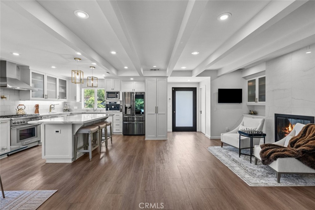 2534 Page Drive Altadena, CA 91001 - Photo 13 of 48 a kitchen with stainless steel appliances granite countertop wooden floors a stove and a refrigerator