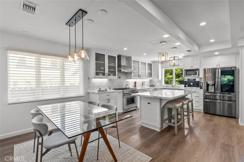 2534 Page Drive Altadena, CA 91001 - Photo 15 of 48 a kitchen with stainless steel appliances granite countertop a kitchen island a stove a table and chairs in it