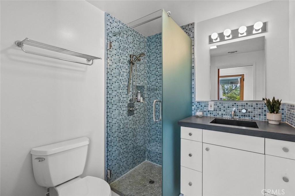 2534 Page Drive Altadena, CA 91001 - Photo 35 of 48 a bathroom with a granite countertop toilet a sink and a mirror