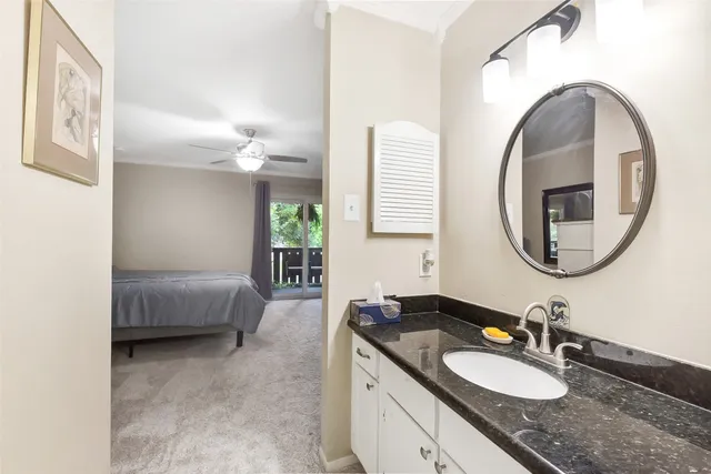 a bathroom with a granite countertop double vanity sink and a mirror