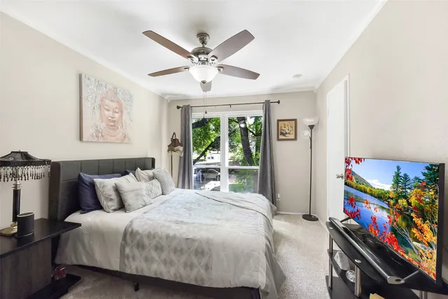 a bedroom with a bed a dresser with wooden floor