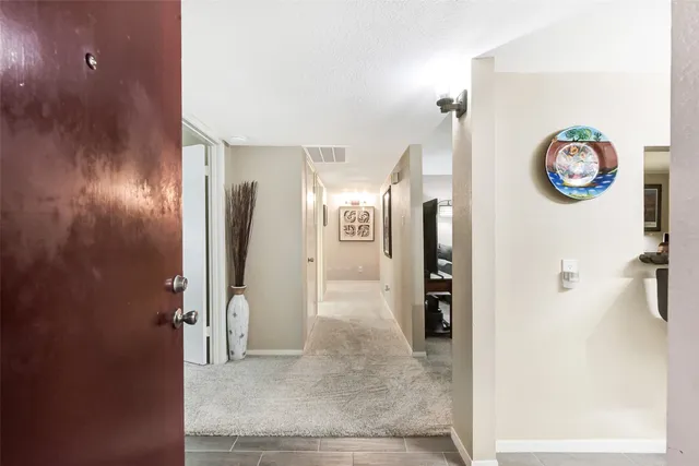 a view of a hallway with wooden shelves