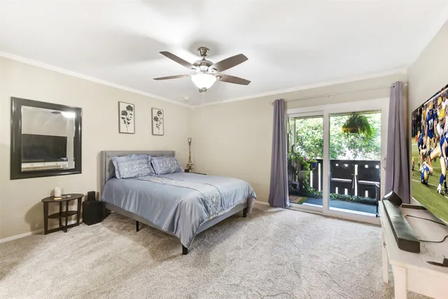 a spacious bedroom with a bed and a flat screen tv