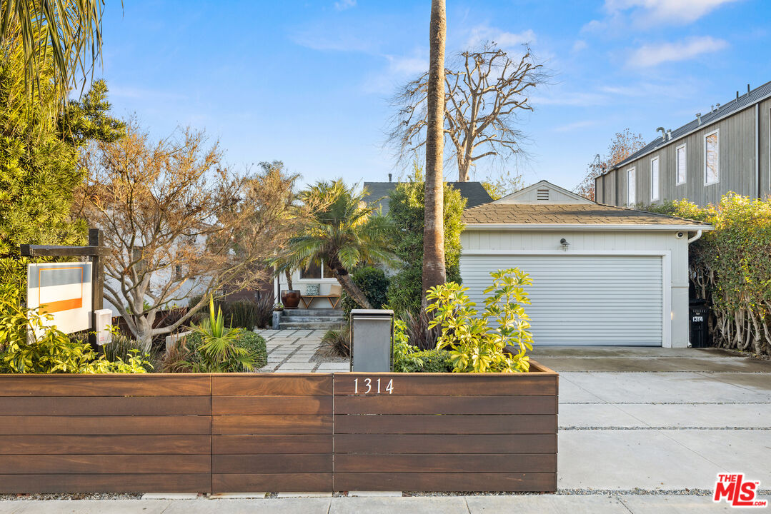 a front view of a house with trees