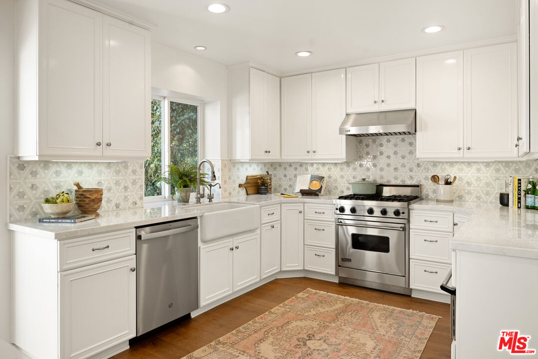 1314 Preston Way Venice, CA 90291 - Photo 13 of 37 a kitchen with granite countertop white cabinets and white appliances