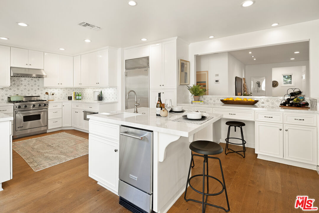 1314 Preston Way Venice, CA 90291 - Photo 18 of 37 a kitchen with a sink a stove a refrigerator and white cabinets with wooden floor