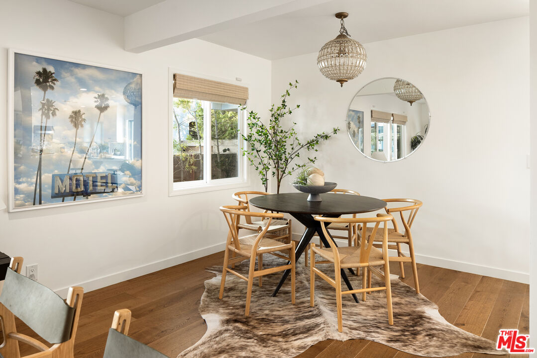 1314 Preston Way Venice, CA 90291 - Photo 9 of 37 a dining room with wooden floor and a chandelier