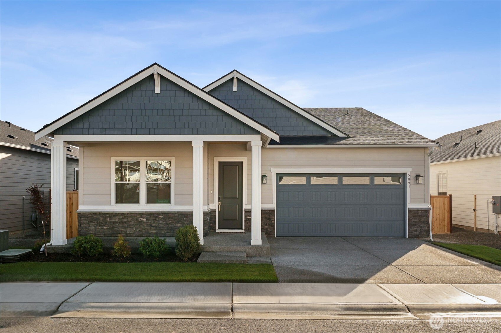 4142 Southwest Muller Lane, Unit 310 Port Orchard, WA 98367 - Photo 1 of 14 a front view of a house with a yard and garage