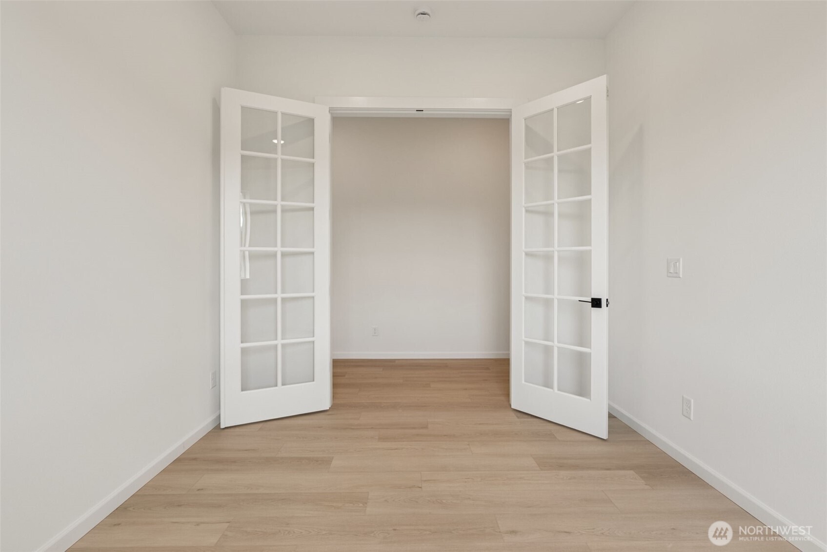 4142 Southwest Muller Lane, Unit 310 Port Orchard, WA 98367 - Photo 3 of 14 an empty room with cabinet and windows