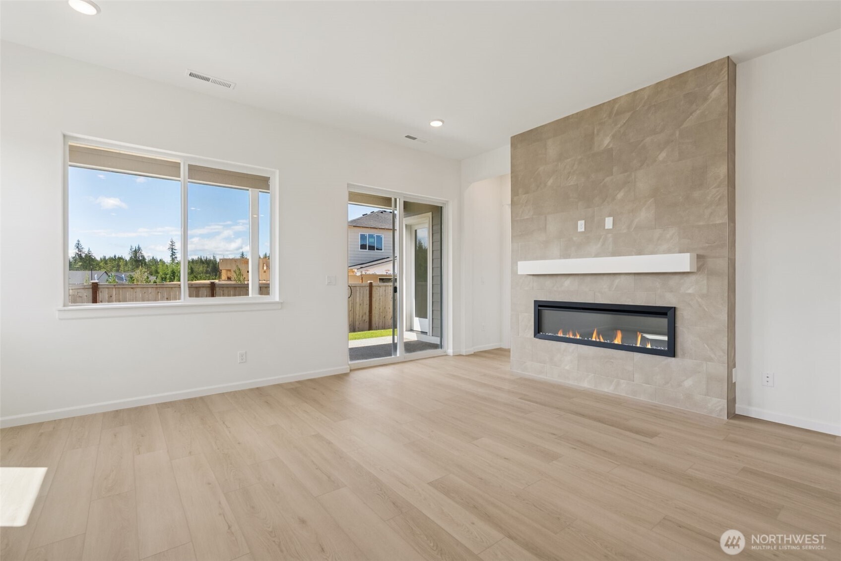 4142 Southwest Muller Lane, Unit 310 Port Orchard, WA 98367 - Photo 7 of 14 a view of an empty room with a window and fireplace