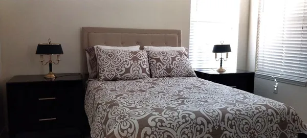 a bedroom with a bed and a mirror