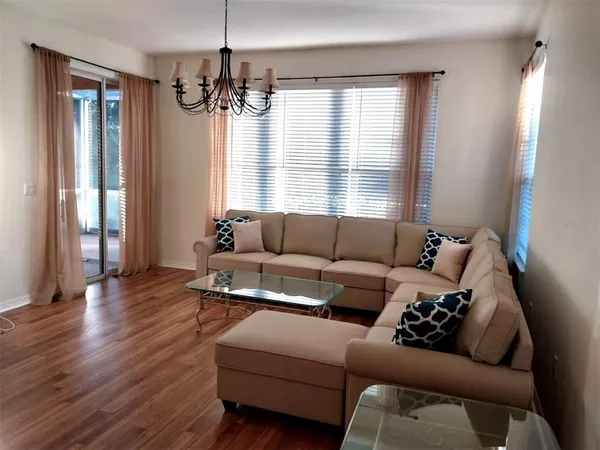 a living room with furniture and a chandelier
