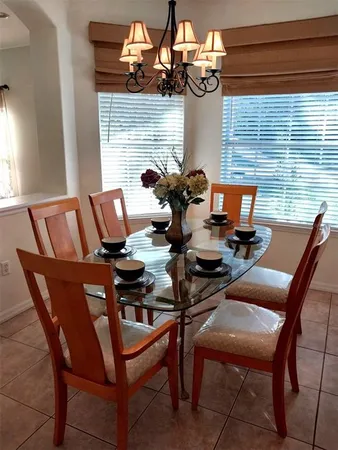 a view of a dining room with furniture and chandelier