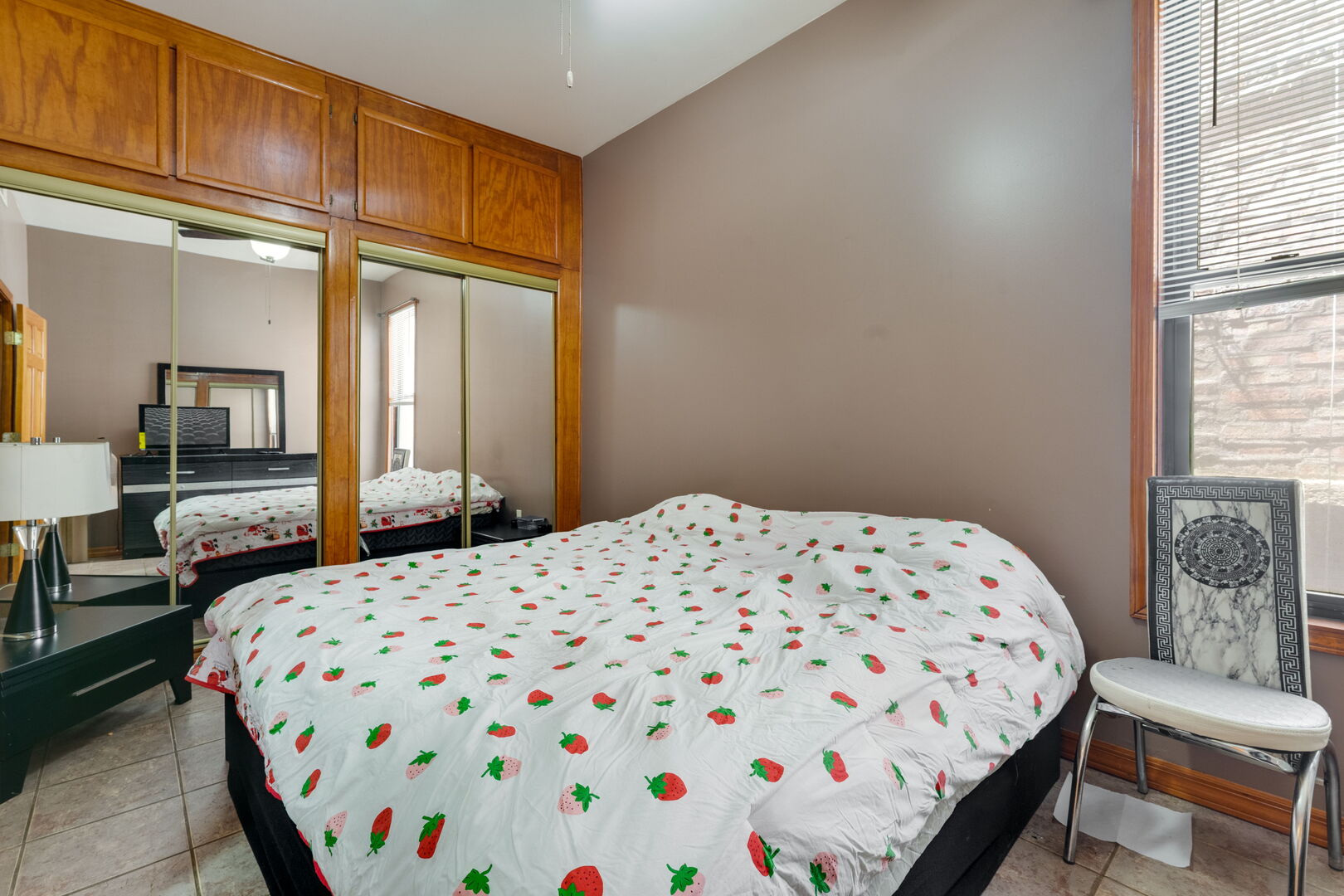 2312 West Taylor Street Chicago, IL 60612 - Photo 10 of 13 a bedroom with a bed lamp and a window