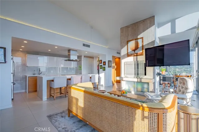 a living room with furniture and a floor to ceiling window