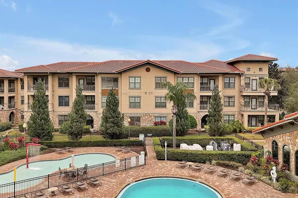 a front view of a house with swimming pool and porch