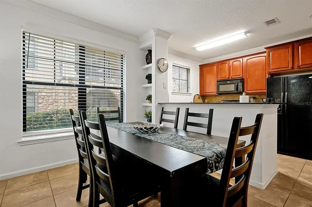 a view of a dining room with furniture and a potted plant