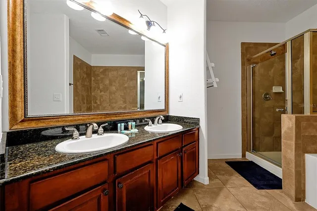 a bathroom with a sink double vanity and a mirror