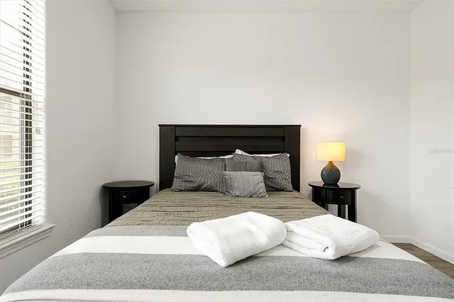 a bathroom with a granite countertop sink toilet and a mirror