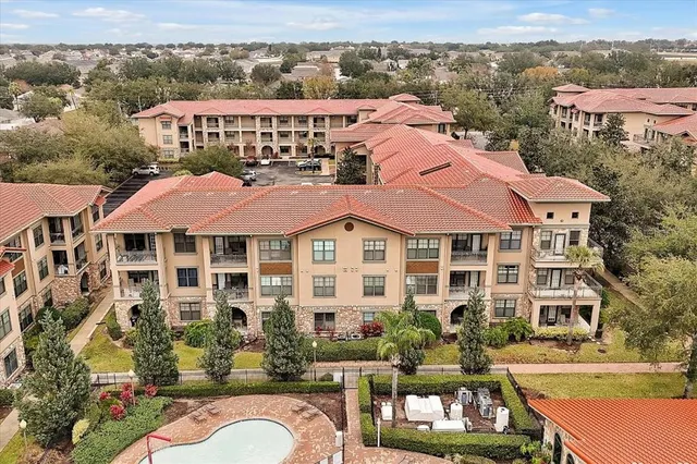 a front view of a residential apartment building with a yard