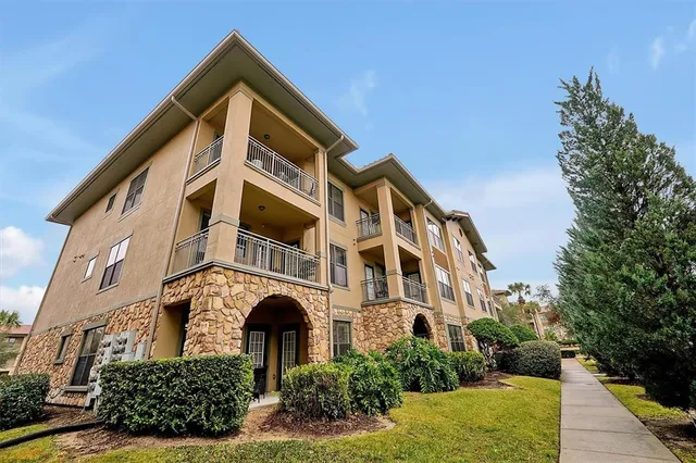 an aerial view of residential houses with outdoor space and parking