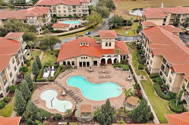 an aerial view of residential house with outdoor space and swimming pool