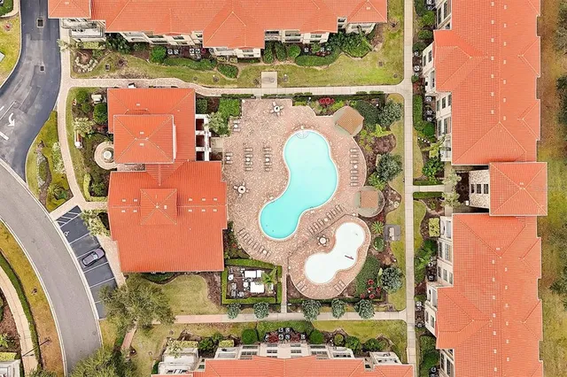 an aerial view of a house with yard swimming pool and ocean view