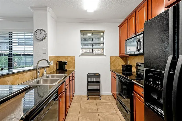 a kitchen with granite countertop stainless steel appliances granite countertop a stove and a microwave