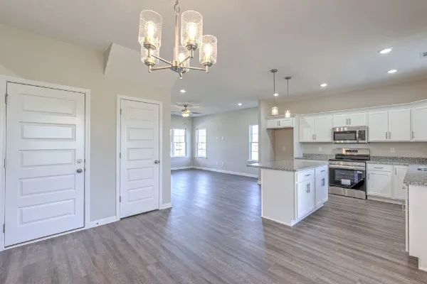 a view of a kitchen with a sink and dishwasher a kitchen view with wooden floor