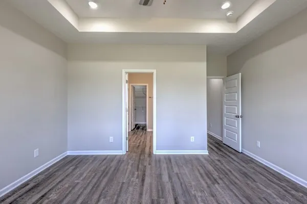 an empty room with wooden floor and closet