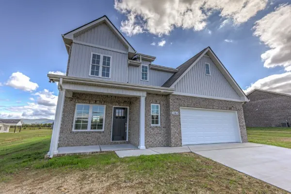 a front view of a house with a yard and garage