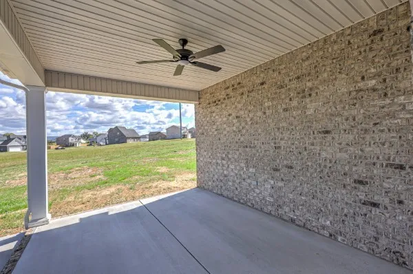 a view of a livingroom with a ceiling fan and a large window