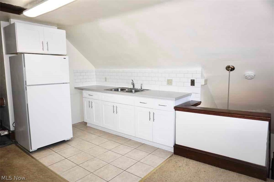 2168 Edgewood Road Cleveland, OH 44118 - Photo 31 of 41 3rd fl kitchenette featuring light tile floors, white cabinets, tile backsplash, and white refrigerator