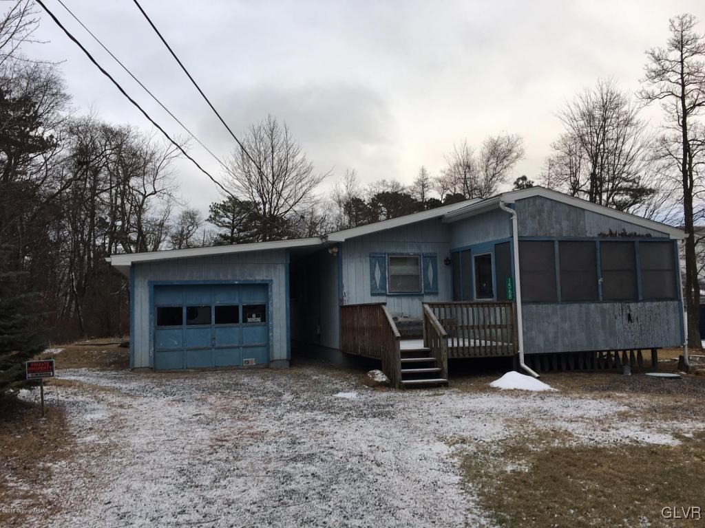 1568 Clover Road Long Pond, PA 18334 - Photo 1 of 14 a view of a house with a yard and garage