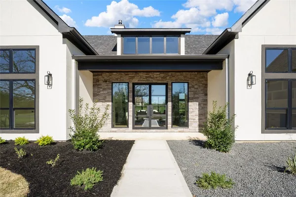 a living room with fireplace furniture and a large window