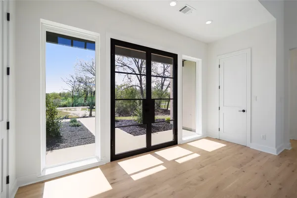a living room with furniture and large windows