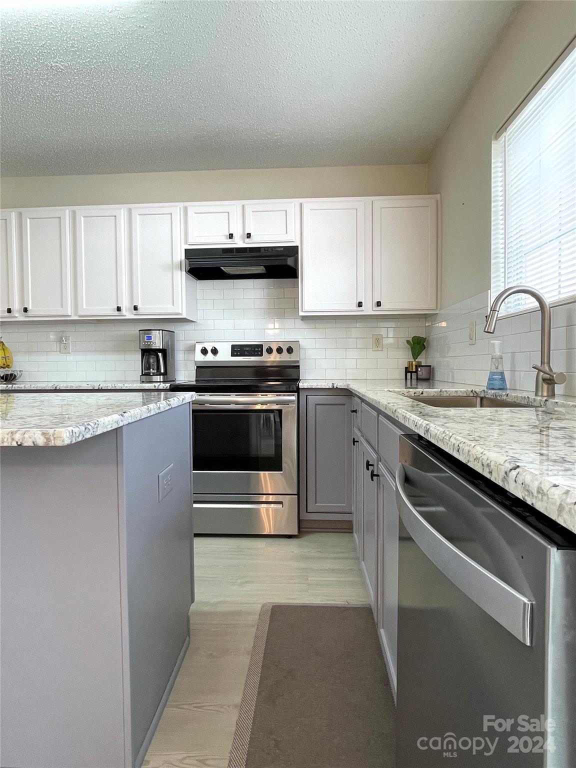 3216 Barons Court Road Charlotte, NC 28213 - Photo 13 of 29 a kitchen with stainless steel appliances granite countertop a stove sink and cabinets