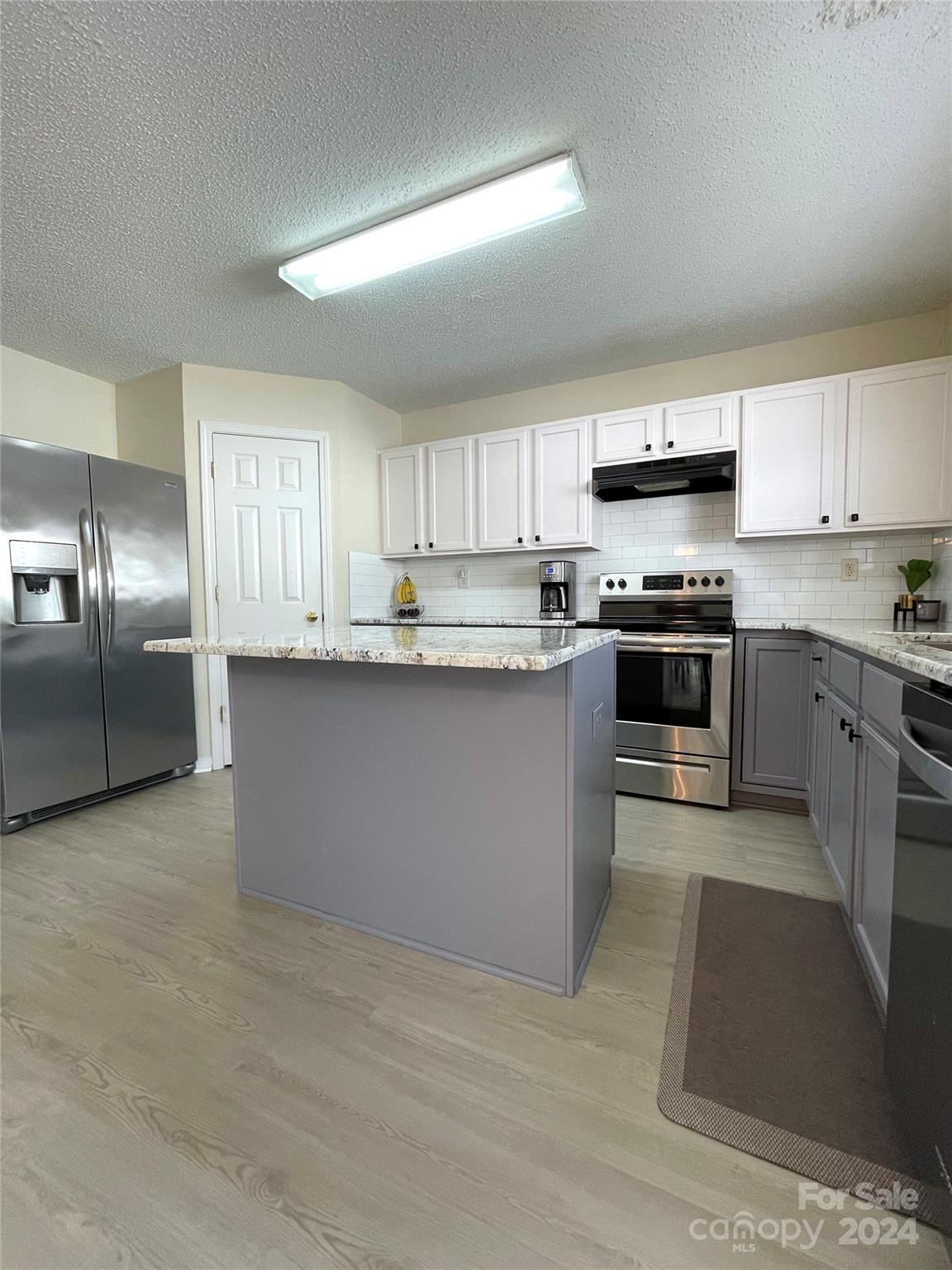 3216 Barons Court Road Charlotte, NC 28213 - Photo 14 of 29 a kitchen with stainless steel appliances granite countertop a stove top oven a sink dishwasher and a refrigerator
