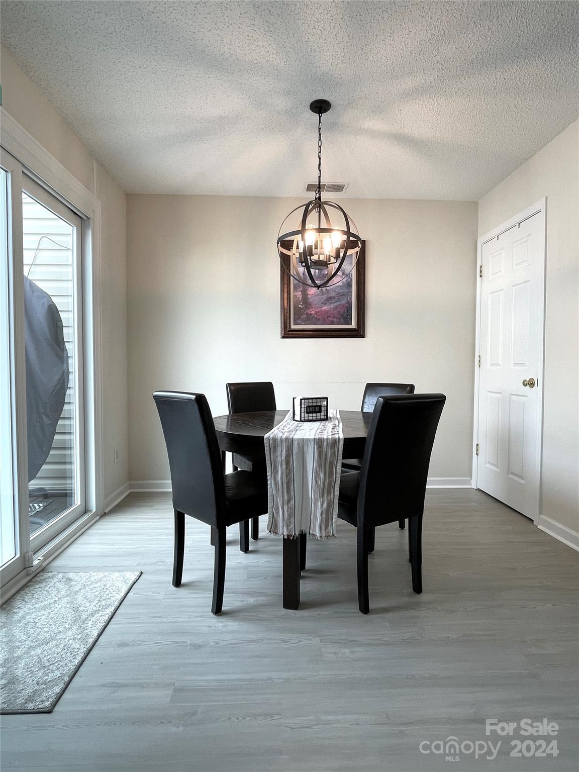 3216 Barons Court Road Charlotte, NC 28213 - Photo 15 of 29 a view of a dining room with furniture wooden floor and chandelier