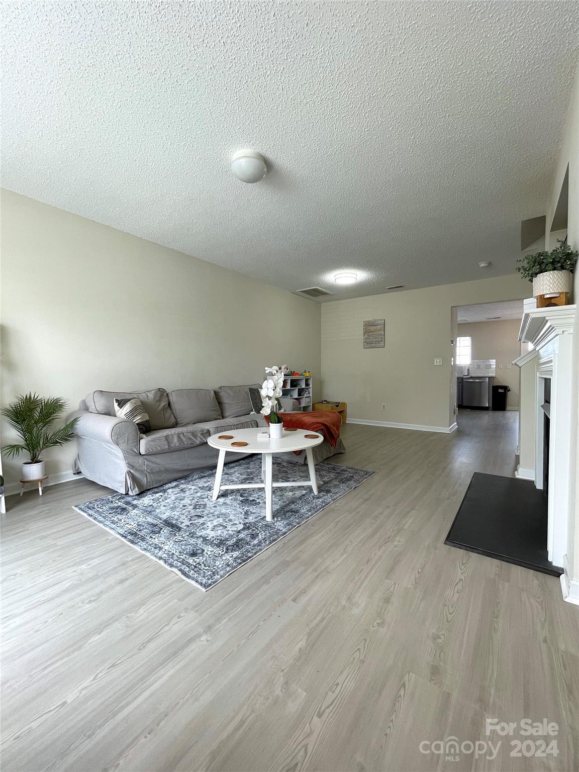 3216 Barons Court Road Charlotte, NC 28213 - Photo 5 of 29 a living room with furniture and a wooden floor