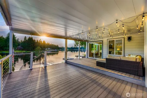a view of a patio with dining table chairs with wooden floor and fence