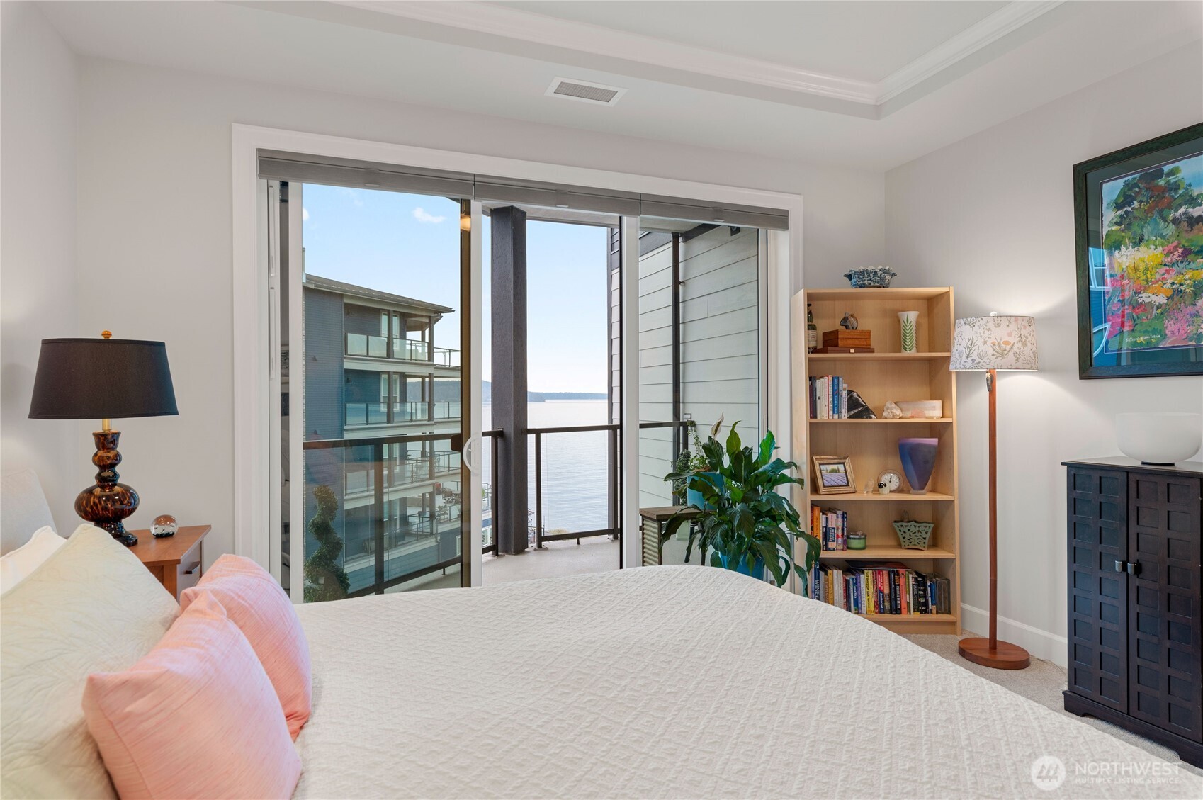 4907 Main Street, Unit 702 Tacoma, WA 98407 - Photo 15 of 33 a bedroom with a bed a dresser and a large window