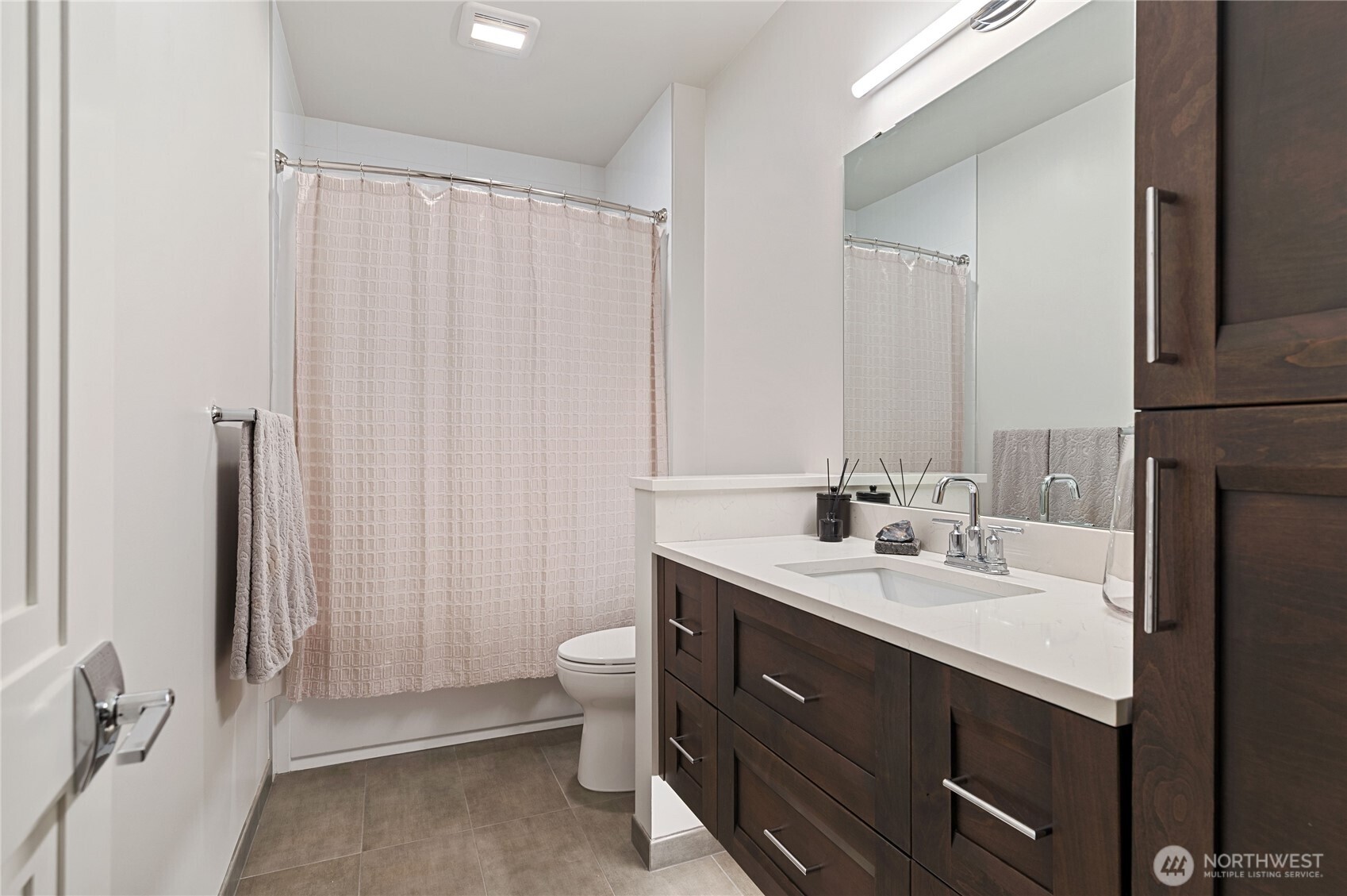 4907 Main Street, Unit 702 Tacoma, WA 98407 - Photo 20 of 33 a bathroom with a double vanity sink a toilet and a mirror