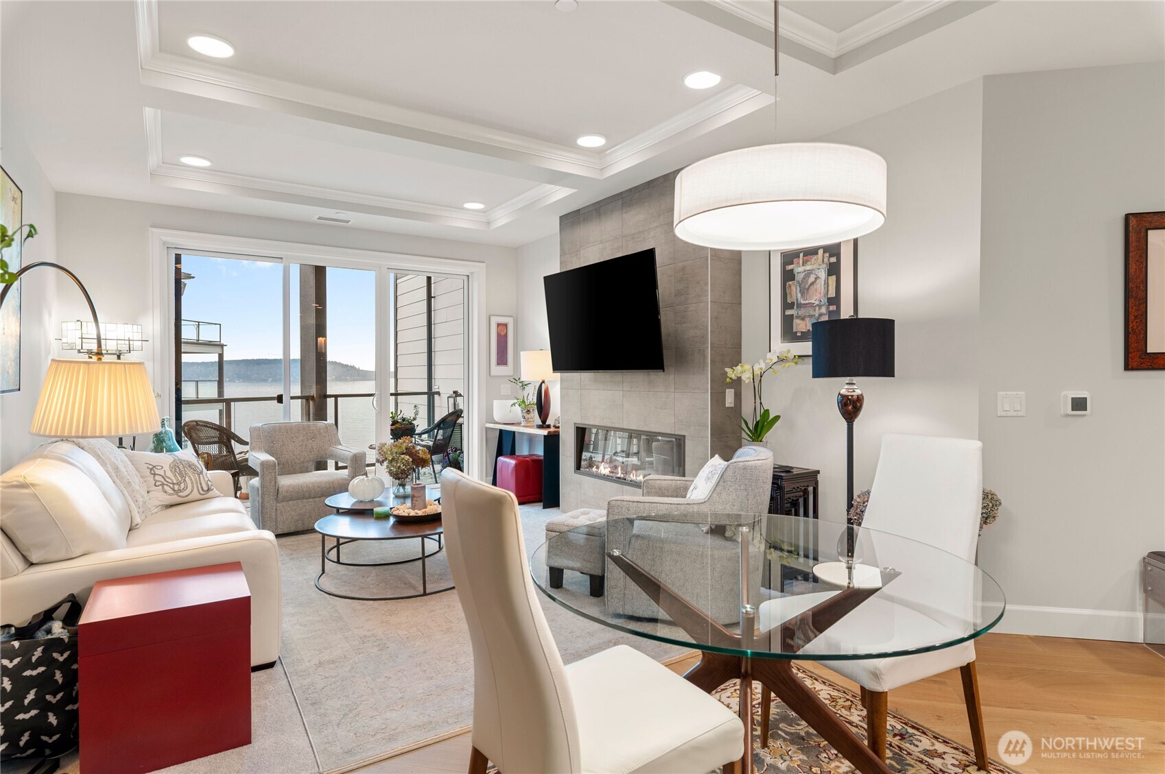 4907 Main Street, Unit 702 Tacoma, WA 98407 - Photo 6 of 33 a living room with furniture a flat screen tv and a large window