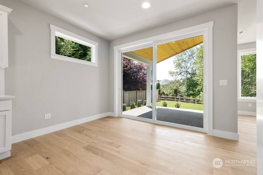 8713 Northeast 204th Street Bothell, WA 98011 - Photo 12 of 25 a view of an empty room with a fireplace and a large window