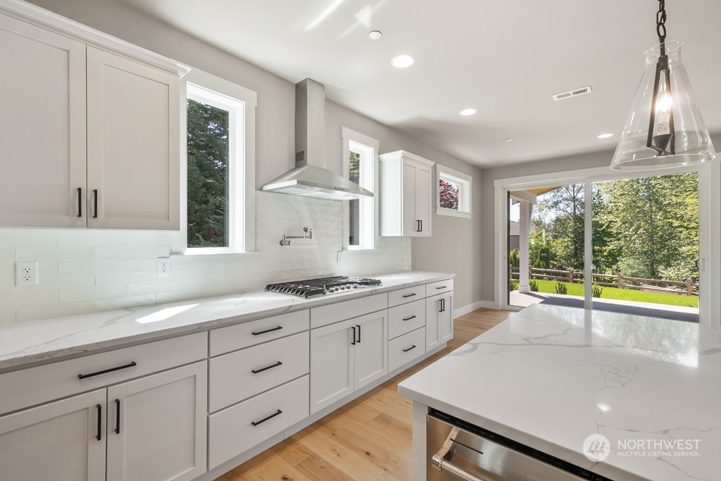 8713 Northeast 204th Street Bothell, WA 98011 - Photo 19 of 25 a kitchen with a sink stove and cabinets