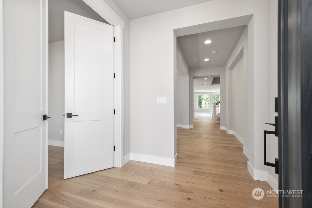 8713 Northeast 204th Street Bothell, WA 98011 - Photo 3 of 25 a view of a hallway with wooden floor