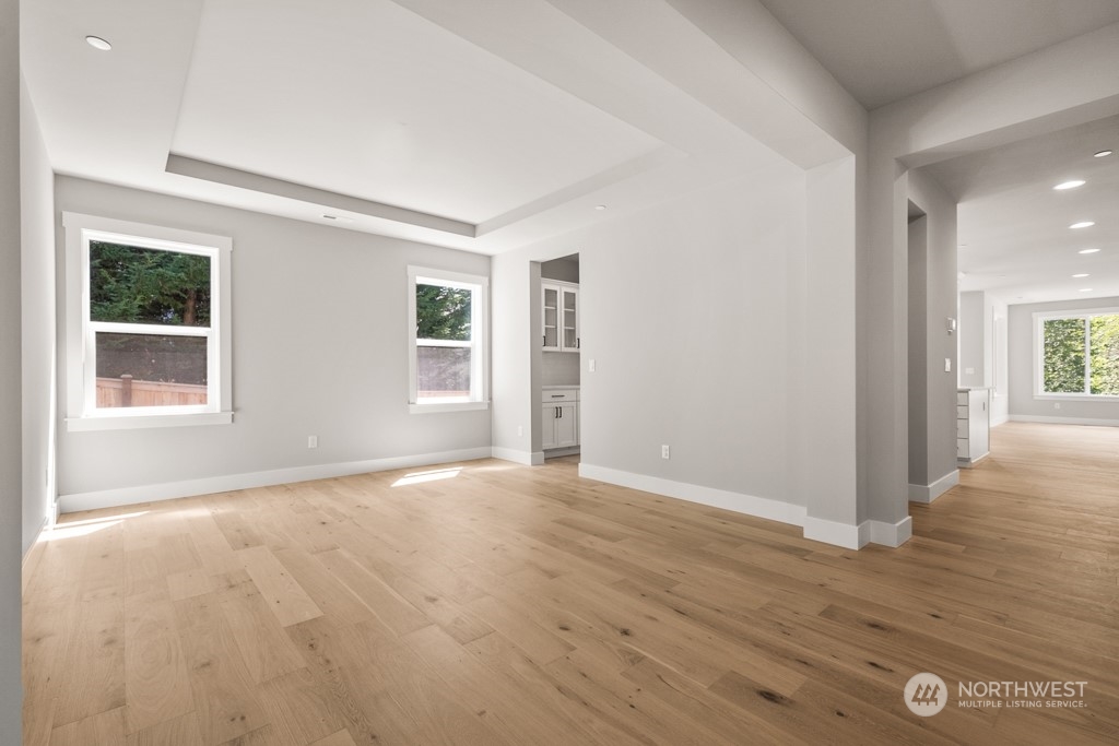 8713 Northeast 204th Street Bothell, WA 98011 - Photo 5 of 25 a view of an empty room with wooden floor and a window
